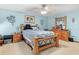 Comfortable bedroom featuring wood bed frame, light blue walls, and a ceiling fan with light fixture at 5 Ridgewood Cir, Mcdonough, GA 30252