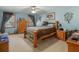 Bright bedroom with a light blue painted walls, a ceiling fan, and natural light coming from large windows at 5 Ridgewood Cir, Mcdonough, GA 30252