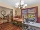 Bright dining room with chandelier lighting, hardwood floors, and sewing space at 5 Ridgewood Cir, Mcdonough, GA 30252