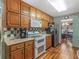 Efficient kitchen features oak cabinets, stainless appliances, and hardwood flooring at 5 Ridgewood Cir, Mcdonough, GA 30252