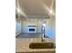 Modern kitchen featuring granite countertops, stainless steel faucet, and view of the fireplace at 502 Clayborne Way, Loganville, GA 30052