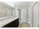 Bathroom with double sink vanity, granite counters, a large mirror, and a shower with a glass door at 5634 Union Pointe Dr, Union City, GA 30291