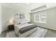 Bright bedroom with a tray ceiling, neutral walls, carpet, and a large window at 5634 Union Pointe Dr, Union City, GA 30291