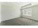 Bright bedroom with tray ceiling, neutral walls, carpet, and window at 5634 Union Pointe Dr, Union City, GA 30291