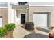 Charming townhome entrance with a black door, white trim, brick accents and an attached garage at 5634 Union Pointe Dr, Union City, GA 30291