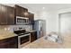 Modern kitchen with granite countertops, stainless steel appliances, dark cabinetry and tile backsplash at 5634 Union Pointe Dr, Union City, GA 30291