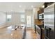 Open kitchen and living space, showcasing stainless steel appliances, hardwood floors and an island sink at 5634 Union Pointe Dr, Union City, GA 30291