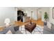 Bright living area with a gray sofa, modern art, hardwood floors and open to the kitchen at 5634 Union Pointe Dr, Union City, GA 30291