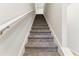 Carpeted staircase with white walls and handrail that leads to the upper level of the home at 5634 Union Pointe Dr, Union City, GA 30291