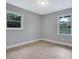Naturally lit bedroom featuring wood-look floors and a pair of bright windows at 1513 Spruce Ridge Way, Stone Mountain, GA 30083