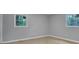 Bedroom showcasing two windows providing exterior views and wood-look flooring at 1513 Spruce Ridge Way, Stone Mountain, GA 30083