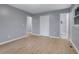 Spacious bedroom with wood-look flooring, closet, and connecting bathroom at 1513 Spruce Ridge Way, Stone Mountain, GA 30083
