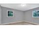 This spacious bedroom has lots of natural light from the two windows at 1513 Spruce Ridge Way, Stone Mountain, GA 30083