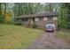 Charming home featuring brick accents, a one-car garage, inviting entrance, and mature trees at 1513 Spruce Ridge Way, Stone Mountain, GA 30083