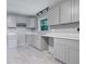 Bright kitchen with gray cabinets, granite countertops, stainless steel appliances, and tile flooring at 1513 Spruce Ridge Way, Stone Mountain, GA 30083