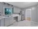 Modern kitchen featuring stainless steel appliances, new flooring, and plenty of cabinet space at 1513 Spruce Ridge Way, Stone Mountain, GA 30083