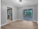 Open living area with wood-look floors and glass doors to a screened porch, flowing into the kitchen at 1513 Spruce Ridge Way, Stone Mountain, GA 30083