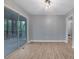 A light-filled living room featuring a sliding glass door to a screened porch and wood-look flooring at 1513 Spruce Ridge Way, Stone Mountain, GA 30083