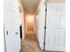 Bright hallway with multiple doors and neutral carpet, creating a welcoming transition space at 1763 Emerald Dr, Jonesboro, GA 30236
