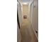 Hallway with multiple white doors and neutral carpeting, lit by a ceiling light at 1763 Emerald Dr, Jonesboro, GA 30236