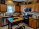 Well-lit kitchen with stainless steel appliances, wood cabinets, granite countertops, and tiled backsplash at 1763 Emerald Dr, Jonesboro, GA 30236