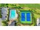 Aerial view of the community pool and tennis courts, surrounded by lush greenery and walking trails at 2650 Longacre Park Way, Lawrenceville, GA 30044