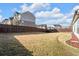 Spacious backyard with wood privacy fence offering room for outdoor activities at 2650 Longacre Park Way, Lawrenceville, GA 30044