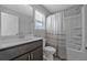 Bright bathroom featuring a shower-tub combination with modern fixtures and vanity at 2650 Longacre Park Way, Lawrenceville, GA 30044