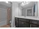 Bathroom with vanity, large mirror, modern sink, and combination shower and tub at 2650 Longacre Park Way, Lawrenceville, GA 30044