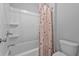 Bathroom featuring a clean white shower-tub combination with a stylish shower curtain and white toilet at 2650 Longacre Park Way, Lawrenceville, GA 30044