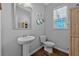 Bathroom featuring a pedestal sink, heart-shaped wall decorations, hardwood floors and natural light at 2650 Longacre Park Way, Lawrenceville, GA 30044