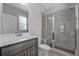 Bathroom featuring a vanity and tiled stand up shower with glass doors at 2650 Longacre Park Way, Lawrenceville, GA 30044