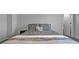 Large bedroom with a cozy bed, stylish bedding, bedside table, and a view of the interior door at 2650 Longacre Park Way, Lawrenceville, GA 30044