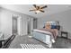 Modern bedroom with mirrored bed frame, soft gray walls, carpeted floors, and ceiling fan at 2650 Longacre Park Way, Lawrenceville, GA 30044