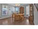 Bright dining room featuring hardwood floors, a wooden table, and abundant natural light from surrounding windows at 2650 Longacre Park Way, Lawrenceville, GA 30044