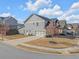 Side view of home showcasing a two-car garage and well-maintained landscaping at 2650 Longacre Park Way, Lawrenceville, GA 30044