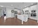 Modern kitchen with white cabinets, hardwood floors, and stainless steel appliances at 2650 Longacre Park Way, Lawrenceville, GA 30044