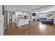 Open-concept kitchen with island seating seamlessly flows into the living room at 2650 Longacre Park Way, Lawrenceville, GA 30044