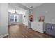 Living room featuring hardwood floors, a ceiling fan, and a built-in storage area with mini-fridge at 2650 Longacre Park Way, Lawrenceville, GA 30044