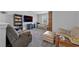 Cozy living room with plush seating, media center, and large TV for relaxation at 2650 Longacre Park Way, Lawrenceville, GA 30044