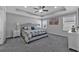 Comfortable main bedroom with a decorative ceiling fan, tray ceiling, and ample natural light at 2650 Longacre Park Way, Lawrenceville, GA 30044