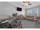 Office featuring a ceiling fan, mounted television with streaming service, couch, and large picture window at 2650 Longacre Park Way, Lawrenceville, GA 30044