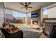 Outdoor patio with brick fireplace, TV, ceiling fan, grill, and comfortable seating at 2650 Longacre Park Way, Lawrenceville, GA 30044