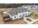 Aerial view of a white brick home with manicured landscaping, benches and walking paths at 3739 Silvery Way, Powder Springs, GA 30127