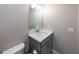 Neutral-toned powder room showcasing a vanity with white countertop and a square mirror at 3739 Silvery Way, Powder Springs, GA 30127
