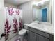 Tastefully designed bathroom featuring a vanity, toilet, and a shower with a leafy curtain at 3739 Silvery Way, Powder Springs, GA 30127