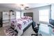 Comfortable bedroom featuring a statement headboard, a ceiling fan, and a home office nook at 3739 Silvery Way, Powder Springs, GA 30127