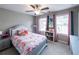 Colorful bedroom with fun decor and a cozy bed, illuminated by natural light at 3739 Silvery Way, Powder Springs, GA 30127