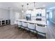 Island kitchen features white cabinetry, counter seating, and stainless steel appliances at 3739 Silvery Way, Powder Springs, GA 30127