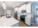 Modern kitchen features white cabinets and stainless steel appliances, offering style and functionality at 3739 Silvery Way, Powder Springs, GA 30127